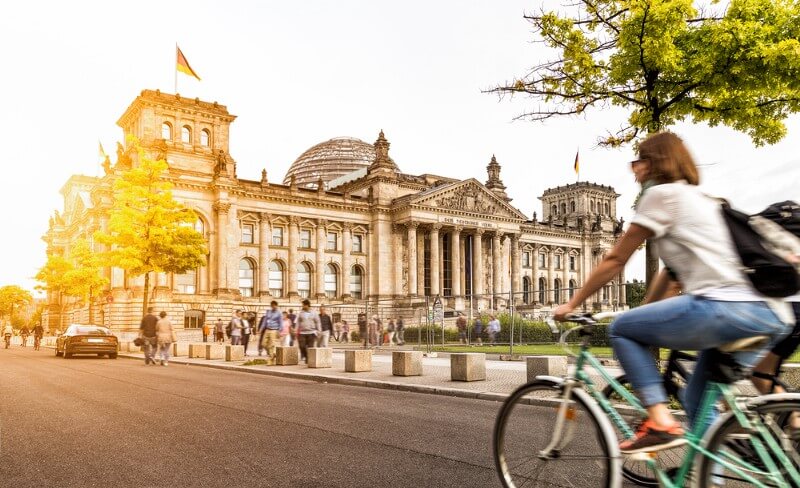 Urban city life with famous Reichstag building in the background, Berlin (Photo: canadastock/Shutterstock)